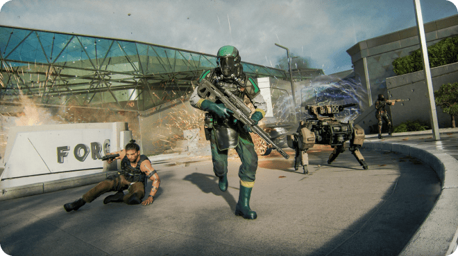 A high-action battle scene in a modern urban setting. A soldier in green armor charges forward with a large rifle as explosions erupt behind him. Another soldier crouches on the ground nearby, while a robotic turret and additional fighters engage in combat across the area.